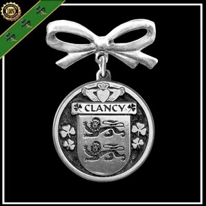 May include: Silver charm with a bow, featuring the Clancy family crest and the text "CLANCY" surrounded by shamrocks.