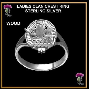 May include: Sterling silver ring with a clan crest featuring a ship. The crest is surrounded by a rope design. The ring is labeled "WOOD".