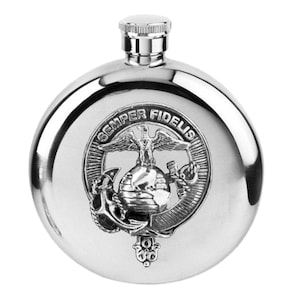 May include: A polished, stainless steel flask with a screw-on cap. The flask features an embossed emblem with an eagle, globe, and anchor, and the words "Semper Fidelis" in a circular design. The flask is round and has a shiny finish.