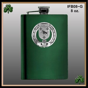 May include: Green stainless steel hip flask with a silver metal crest featuring a bull and the text "CROWLEY". The flask is 8 ounces.