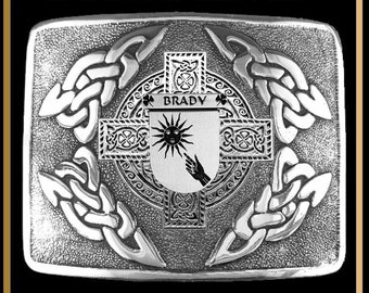May include: Silver kilt buckle with an intricate Celtic knot design. The center features a shield with the name "BRADY" and a sun with a hand reaching up.