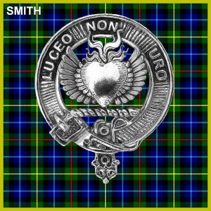 May include: A silver and white Scottish clan crest with the text "LUCEO NON URO" around the outside. The crest features a heart with flames on top and wings on either side. The crest is on a green, blue, and yellow plaid background. The text "SMITH" is in the top left corner.