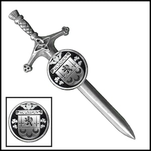 May include: Silver-toned kilt pin in the shape of a sword with a round crest featuring the text "Mc Loughlin" and a lion, shamrocks, and crescent moons.