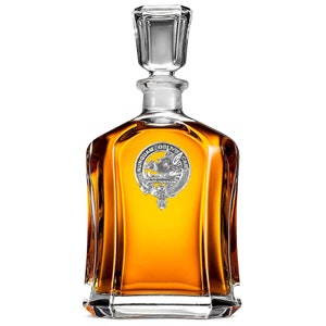 May include: A clear glass decanter with a silver crest featuring a boar and the text "NUNQUAM OBLIVISCAR".
