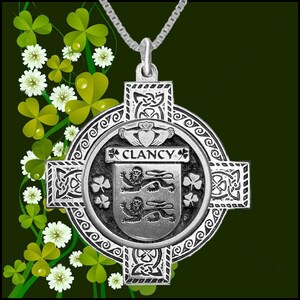May include: Silver Celtic cross pendant necklace with a silver shield featuring the Clancy family crest and the text "Clancy" in a silver banner. The shield is surrounded by shamrocks and a Celtic knot design.