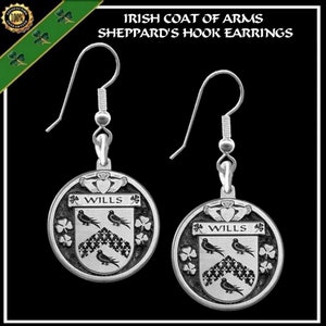 May include: Silver earrings with a round pendant featuring the Wills Irish coat of arms. The pendant has a silver shield with three black birds and a shamrock design. The text "WILLS" is printed on the shield.