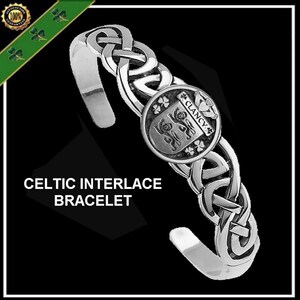 May include: Silver Celtic Interlace bracelet with a round charm featuring a crest and the text "Clancy".