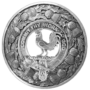 May include: A silver metal Scottish clan crest with a rooster design and the text "Commit thy work to God" surrounded by thistles.