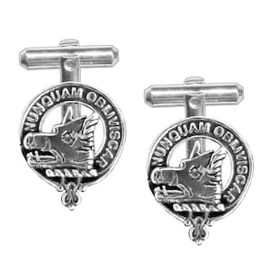 May include: A pair of silver cufflinks featuring a boar's head with the text "NUNQUAM OBLIVISCAR" around the head.
