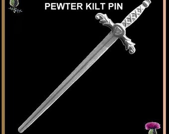 May include: A silver pewter kilt pin shaped like a sword, featuring a heart-shaped design on the hilt. This pin is a traditional Scottish accessory.