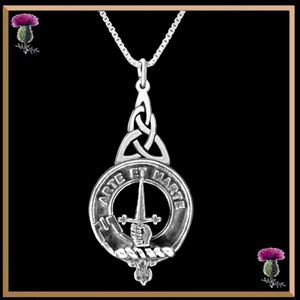 May include: Silver pendant necklace featuring a Celtic knot design and a circular crest with the words "Arte et Marte" and a sword and hand holding a sword.