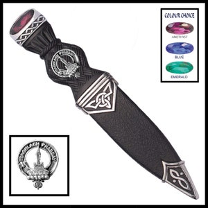 May include: A black leather scabbard with a silver Celtic knot design and a silver and black handle. The handle features a silver crest with the words "Teachlach Phabaey" and a silver gem.