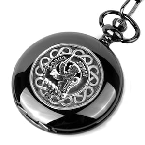 May include: Black pocket watch with a silver-toned Celtic knot design featuring a lion rampant and the text "Deus Juvat".