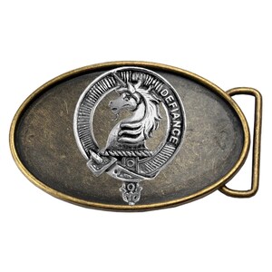 May include: A silver and gold oval belt buckle with a silver unicorn crest and the word "DEFIANCE" inscribed around the crest.
