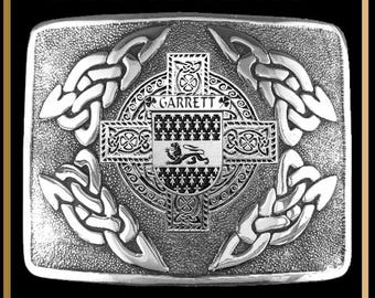 May include: A rectangular silver-toned kilt buckle featuring the text INTERLACE KILT BUCKLE BUC3. The buckle displays an intricate Celtic knotwork pattern surrounding a central cross and a shield with the name GARRETT and a lion emblem.