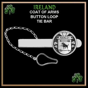 May include: Silver tie bar with a silver chain and a round silver charm featuring the Hanley coat of arms. The charm has a green shamrock design and the text "HANLEY" in a black font.