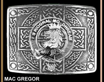 May include: Silver Celtic cross kilt buckle with a lion crest and the words "S Rioghal Mo Dhream" in a circle around it. The buckle is decorated with intricate knotwork and has a textured surface.  Mac Gregor Highland Celtic Cross Kilt Buckle.