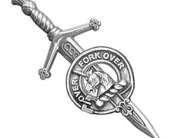 May include: A silver kilt pin featuring a sword and a circular crest with a unicorn and the text "Fork Over".