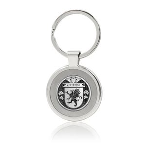 May include: Silver keyring with a round metal tag featuring a black and white crest with the name "GRIFFIN" and a heraldic griffin. The crest is surrounded by four shamrocks.