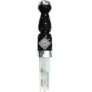 May include: A Scottish dirk with a black woven handle adorned with silver studs and a decorative silver emblem. The blade is engraved with a floral pattern. The dirk has a silver pommel and a silver bolster.