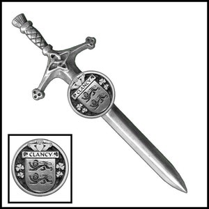 May include: Silver-toned Celtic sword paperweight with a round crest featuring the Clancy family crest and the text "Clancy".