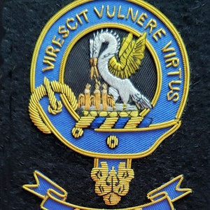 May include: A blue and gold embroidered crest with a white bird and the text "Virescit Vulnere Virtus" and "Stewart" on a black background.