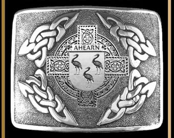 May include: A rectangular silver-toned kilt buckle featuring an intricate Celtic interlace pattern surrounding a central cross and a shield crest with the text AHEARN and three bird figures. The text INTERLACE KILT BUCKLE BUC3 is at the top.