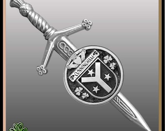 May include: Silver kilt pin featuring a sword with a round shield. The shield has a black and white crest with three stars and the text "CUNNINGHAM".