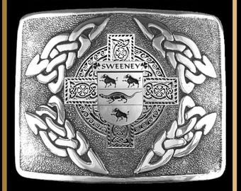 May include: A rectangular silver-toned kilt buckle featuring an intricate interlace knotwork pattern surrounding a central cross and a shield crest. The shield displays the text SWEENEY above three animal figures. The text INTERLACE KILT BUCKLE BUC3 appears above.