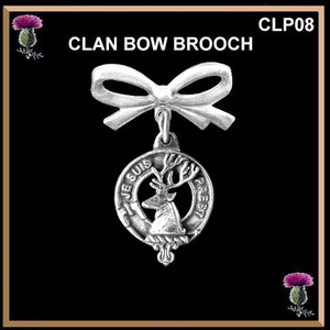 May include: Silver clan bow brooch with a white bow and a round pendant featuring a stag head with the text "Je Suis Presti" in a circle.