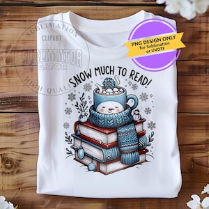May include: White t-shirt featuring a winter-themed graphic. The design includes a smiling snowman mug wearing a scarf, resting on a stack of books. The text "SNOW MUCH TO READ!" is above the mug. A purple circle with text is in the upper right.