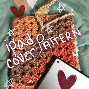 May include: A crocheted iPad cover in shades of brown, orange, and cream. The cover has a simple, textured design and is shown on top of a tablet with a heart drawn on the screen. The text "iPad cover pattern" is written on the image.