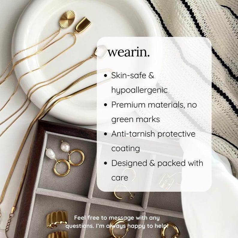 May include: Gold-toned necklaces with oval and U-shaped pendants, pearl and hoop earrings, and gold rings in a gray velvet jewelry tray. Text reads: wearin. Skin-safe & hypoallergenic, Premium materials, no green marks, Anti-tarnish coating.