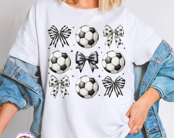 May include: White t-shirt with a soccer design. The design features soccer balls and bows in black and white patterns. The text "HIGH-QUALITY PNG" is at the bottom of the shirt.
