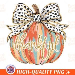 May include: A colorful pumpkin with a gold glitter finish and the word "thankful" written on it. The pumpkin is topped with a black and white polka dot bow.