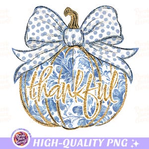 May include: A blue and white pumpkin with a gold glitter design and the word "thankful" written in gold glitter. The pumpkin has a blue and white polka dot bow on top.