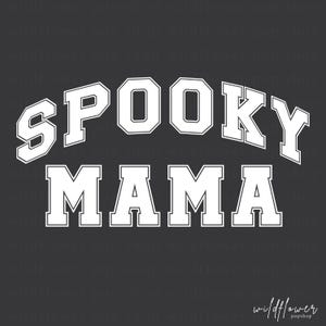 May include: A dark gray graphic design featuring the white text SPOOKY MAMA in a bold, collegiate-style font. The word SPOOKY is arched above the word MAMA, which is written in a straight line. A faint watermark repeats the text wildflower pop shop.