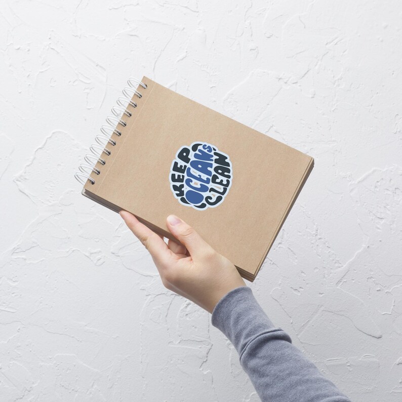 May include: A brown spiral notebook with a blue and black sticker that says "Keep Oceans Clean".