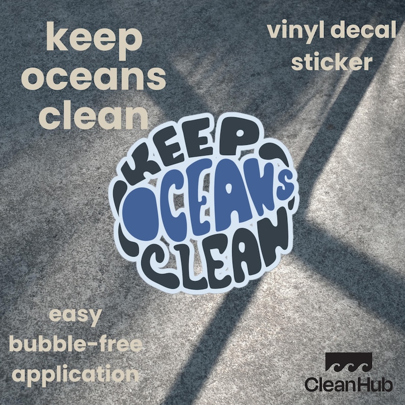 May include: A vinyl decal sticker with the text "Keep Oceans Clean" in a blue and black circular design. The sticker is on a gray concrete surface.