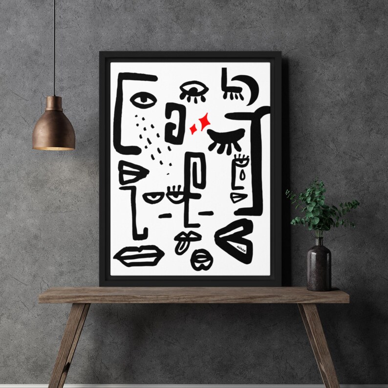 May include: Black and white abstract art print with red accents. The print features various shapes and lines that resemble eyes, lips, and other facial features.