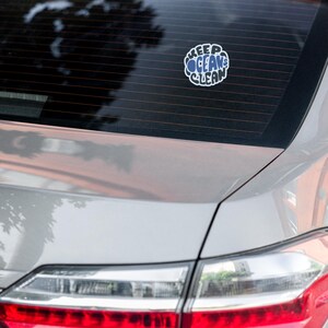 May include: A silver car with a sticker on the back window that says "Keep Oceans Clean".