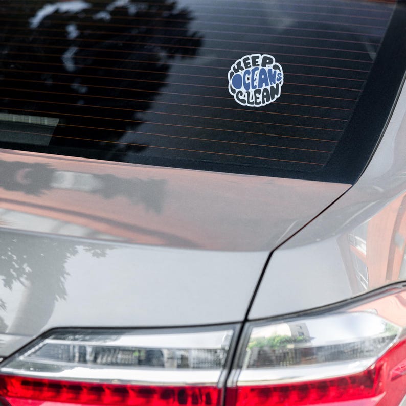 May include: A silver car with a sticker on the back window that says "Keep Oceans Clean".