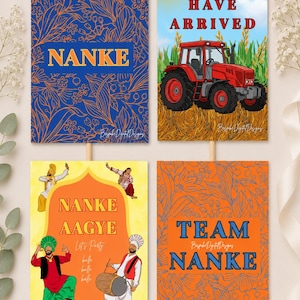 May include: Four rectangular signs on sticks featuring colorful designs. One has a blue floral pattern with the text NANKE. Another shows a red tractor in a field with NANKE HAVE ARRIVED. A third displays dancers with NANKE AAGYE. The last is orange with TEAM NANKE.