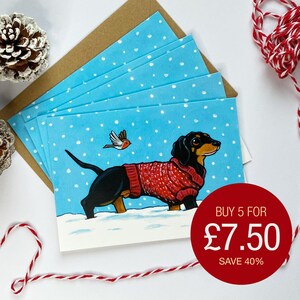 お祝いのダックスフントのクリスマスカード – 雪の中のソーセージ犬とロビン、内側は空白