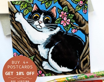 May include: A black and white cat with big eyes is climbing a tree branch. The tree has pink flowers and green leaves. The background is blue. "BUY 4+ POSTCARDS GET 10% OFF SEE LISTING FOR DETAILS" is written on a red circle.