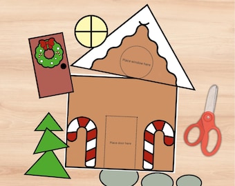 May include: A printable gingerbread house craft activity with instructions to cut out shapes. The gingerbread house is brown with a white roof and candy cane accents. There are two green trees, a red door with a wreath, and a yellow window. The instructions say "Place window here" and "Place door here".