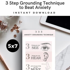 May include: A white 5x7 printable with the text "3 Step Grounding Technique to Beat Anxiety" and "Instant Download." The design includes sections for things to see, hear, and move, with related illustrations. A pen, push pins, and a tablet are also visible.
