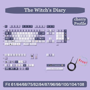 May include: A keyboard keycap set in a light purple and white color scheme, with the text "The Witch's Diary". The set includes keys for various keyboard sizes, with a "cherry Profile". A keycap puller is included.