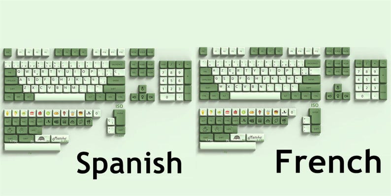 May include: A green and white keyboard keycap set with a Spanish and French layout. The keycaps feature a green color with white lettering. The keycaps are arranged in a standard keyboard layout with the Spanish and French language characters.