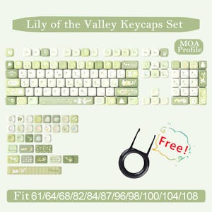 May include: A Lily of the Valley keycap set in MOA profile with light green and white colour schemes, featuring various floral and character graphics. The set includes a black keycap puller and is compatible with 61, 64, 68, 82, 84, 87, 96, 98, 100, 104, and 108 key layouts.